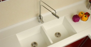Duel tub, solid surface sink with modern faucet.